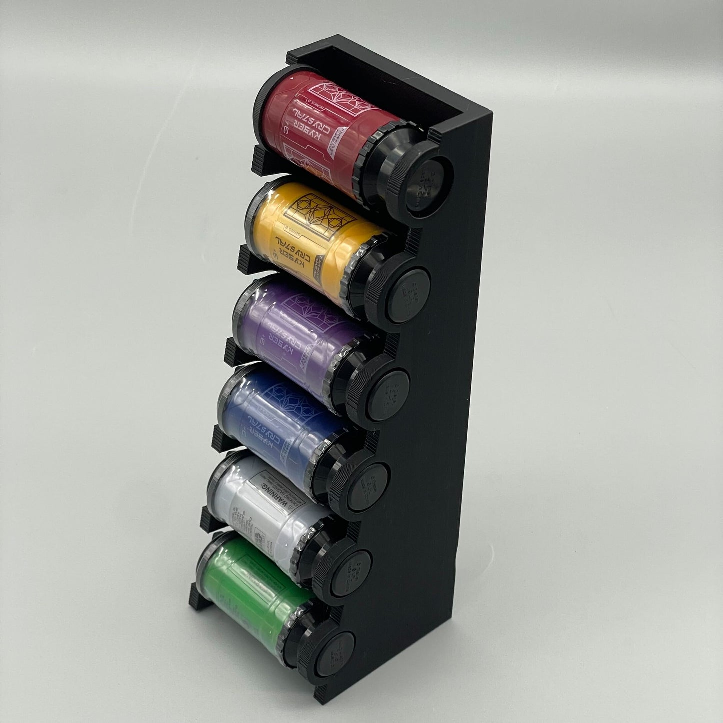 A black display stand with multiple crystal figurines in various colors stored vertically in cylindrical tubes.