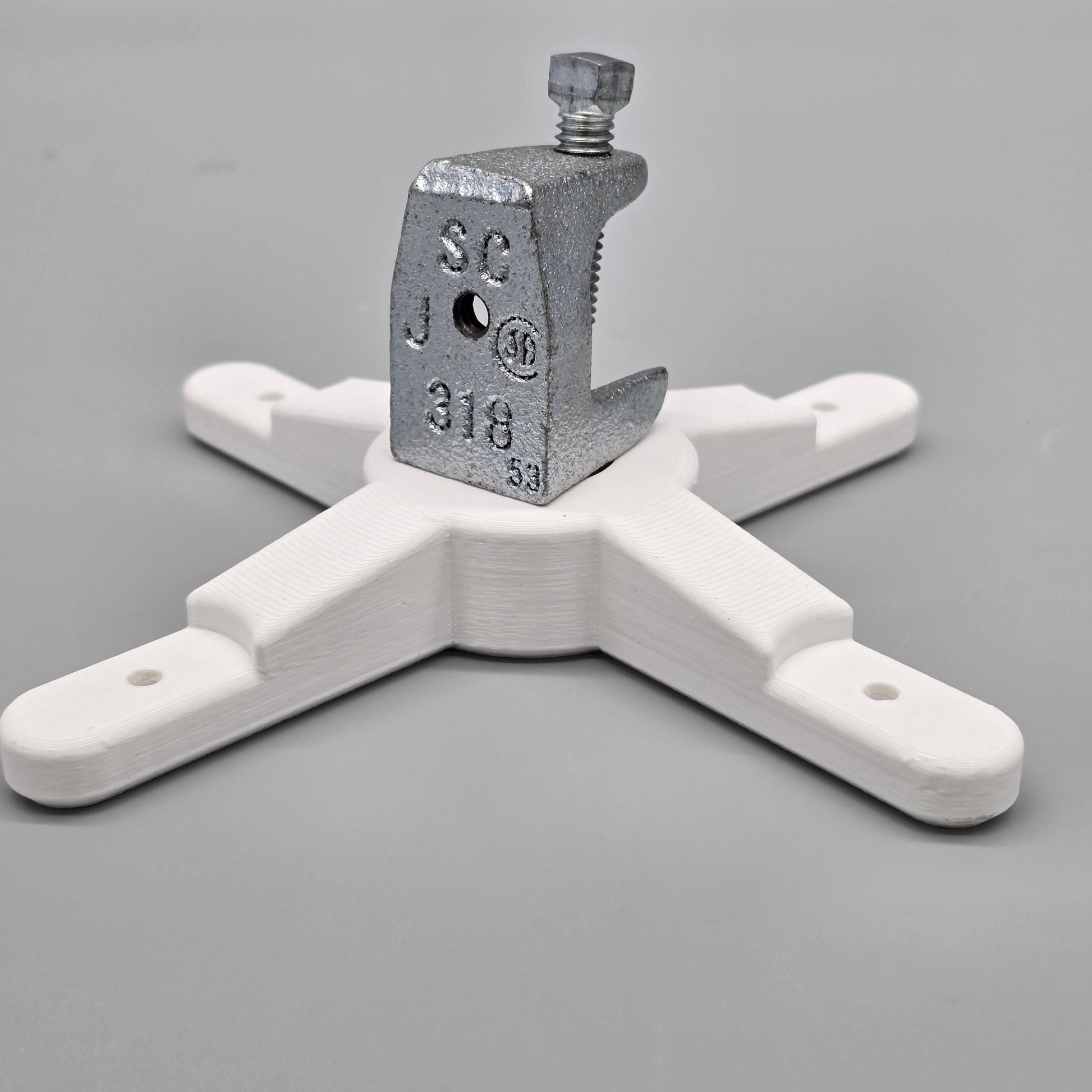 White plastic clamp with metal clamp on a gray background